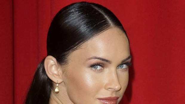 Megan Fox shows off some of her stamps, including a portrait of Marilyn Monroe on her arm she famously removed by laser last year.