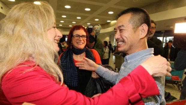Friends greet Chinese-Australian artist Guo Jian as he arrives at Syndey airport after being deported from from China.