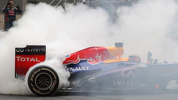 Vettel does a burnout to celebrate winning the Indian GP and another world title.