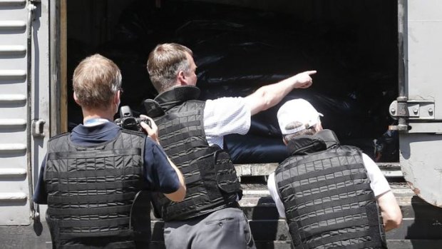 Grim task: OSCE monitors inspect the train at Torez.