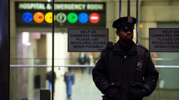On guard: A policeman stands at the entrance to New York's Bellevue Hospital after the city's first case of Ebola was confirmed. 