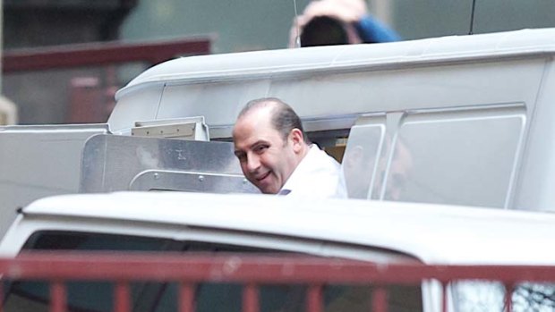 Former drug lord Tony Mokbel makes his way from a prison van into the Supreme Court yesterday.