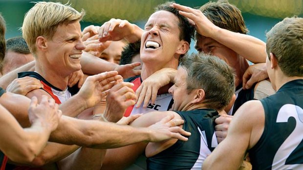 Oh yeah: Nick Riewoldt and the retiring Jason Blake and Justin Koschitzke join in St Kilda celebrations.