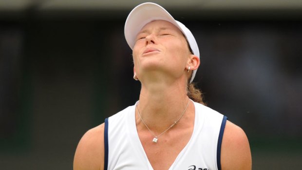 Samantha Stosur shows her frustration during her second-round defeat to the Netherlands' Arantxa Rus at Wimbledon.