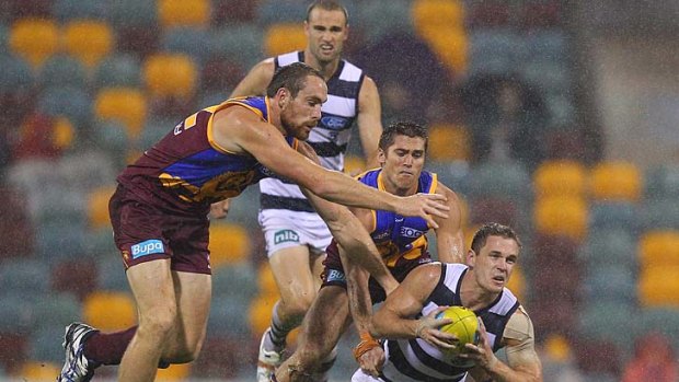Joel Selwood toughs it out in the wet against Brisbane. He will be there again next week to carry the Geelong flag.