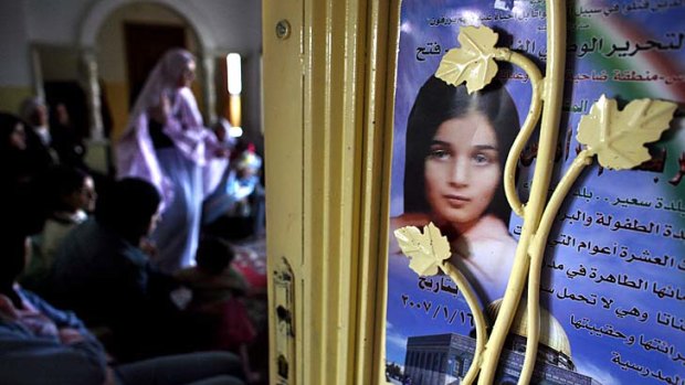 A memorial poster showing 10-year-old Palestinian Abir Aramin is seen on the door of the family home.