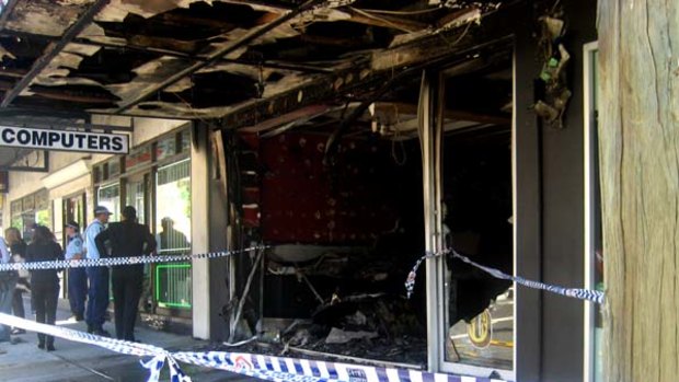 The scene outside the petrol-bombed tattoo parlour on Coogee Bay Road in Sydney's eastern suburbs.