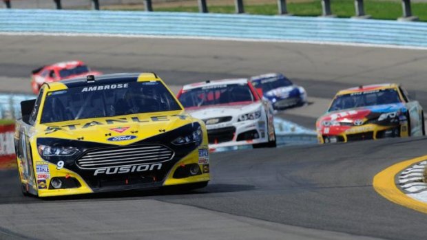 Road warrior: Marcos Ambrose leading the 2013 NASCAR Sprint Cup race at Watkins Glen, NY.