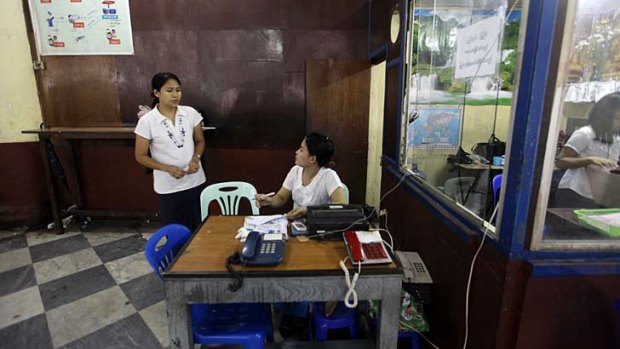 Workers at a public call office phone shop at the Post and Telecommunications division head office in Yangon.