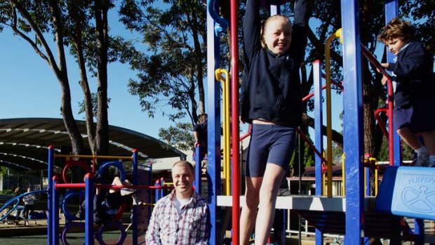 Doug Garske, fund-raising vice-president of Lane Cove West P&C with his daughter Tyler and student  Gabriel Lucarelli using the playground the P&C funded.
