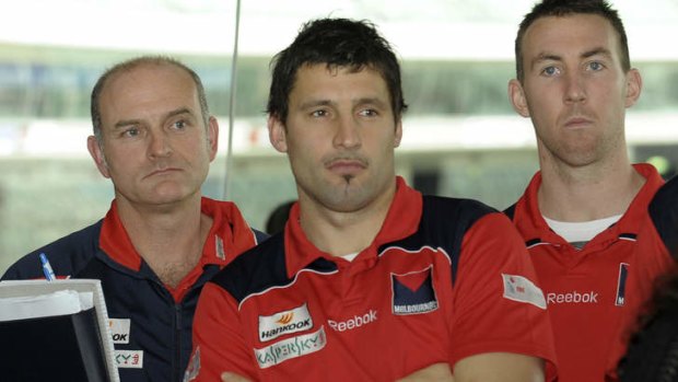 At odds: Former coach Dean Bailey with then Demons Russell Robertson and Brock McLean, who have both spoken out on tanking.