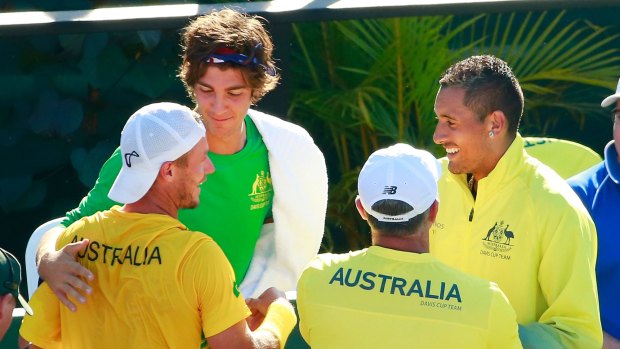 Dog days are over: Thanasi Kokkinakis, Nick Kyrgios and Wally Masur, captain of Australia congratulate teammate Lleyton Hewitt after his reverse singles win last month.