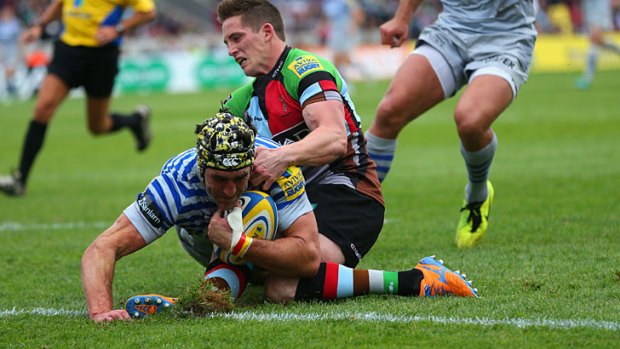 Tom Williams of Harlequins stops Kelly Brown from scoring a try.