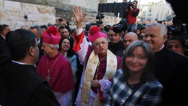 Latin Patriarch of Jerusalem Fouad Twal, centre, arrives to the Church of the Nativity, traditionally believed by Christians to be the birthplace of Jesus Christ on Christmas Eve in the West Bank town of Bethlehem.