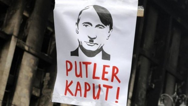 Sign of the times: Vladimir Putin is depicted as Hitler at a demonstration in Kiev on Sunday.
