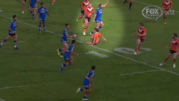 Controversial incident: Tigers halfback Luke Brooks hits the deck in the lead-up to Will Hopoate's disallowed try.