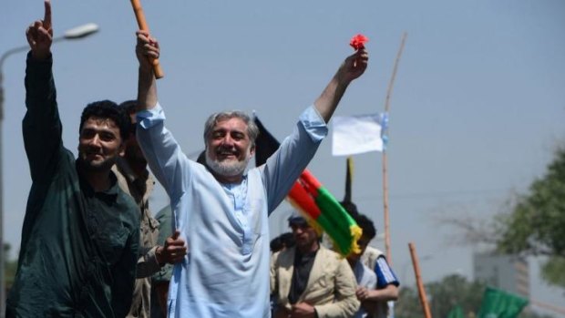 Vowed to reject the election result: Afghan presidential candidate Abdullah Abdullah greets supporters during a demonstration in Kabul on Friday.