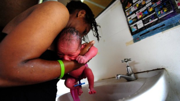 A newborn is bathed in the maternity ward at Port Moresby General Hospital.