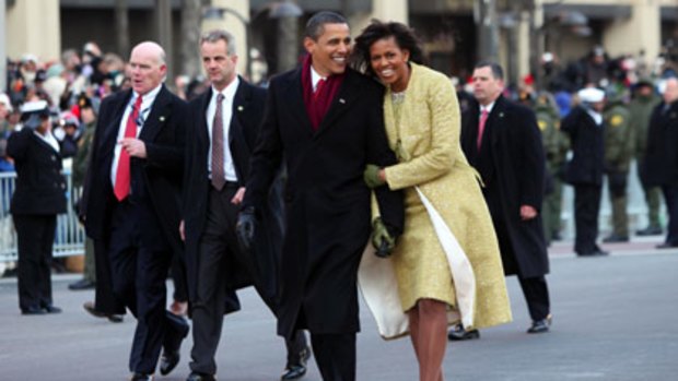 Barack and Michelle Obama walk the inaugural parade route after Mr Obama was sworn in as 44th US President today.