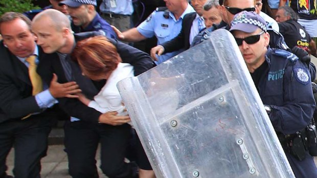 Lost her blue-suede shoe ... Prime Minister Julia Gillard leaves the restaurant.