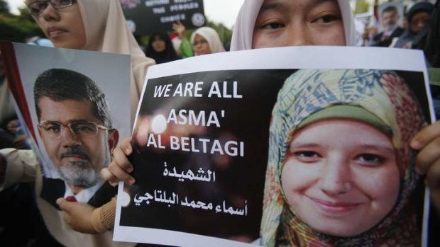 Support: Demonstrators wave Asma's photograph.