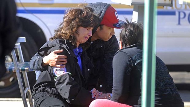 Comforted &#8230; an unidentified woman outside a townhouse in Aurora, Colorado, where four people, including the gunman, died.