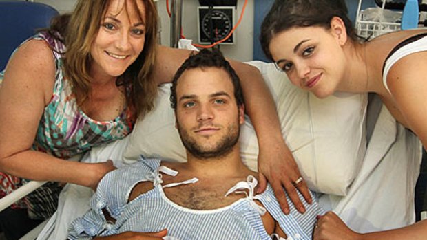 Blake Granston with his mother Michelle (left) and sister Emily (right) recovers in his hospital bed.