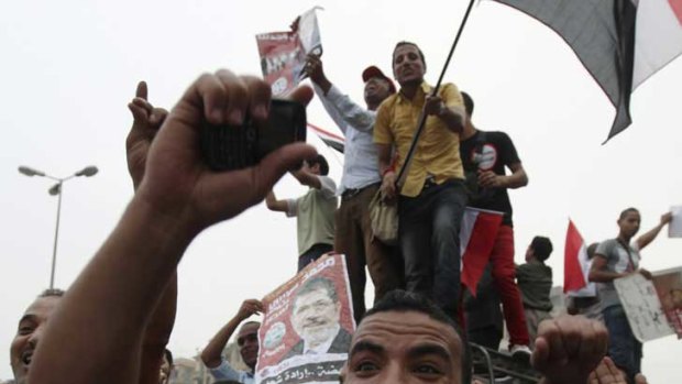Supporters of Muslim Brotherhood presidential candidate Mohammed Morsi celebrate his proclaimed win at Tahrir Square in Cairo.