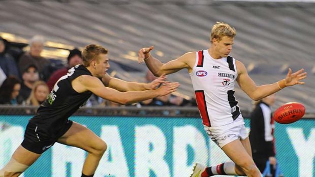 In better Nick: St Kilda captain Nick Riewoldt gets a kick away from Port Adelaide's Jackson Trengove during his side's 56-point win yesterday.