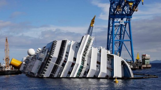 A general view of the capsized cruise liner Costa Concordia surrounded by cranes.