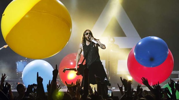 Personality plus: Jared Leto performs in Sydney on Saturday night, amid these ''charming, soon irritating'' giant balloons which were sent over the audience during <em>Kings and Queens</em>.
