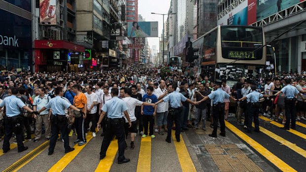 Police form a line to prevent onlookers from entering an area being used by pro-democracy protestors in Kowloon.