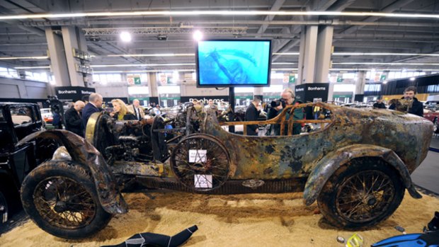 Corroded classic ... the rare  1925 Bugatti Brescia roadster, retrieved from a lake last year,  on show in Paris.