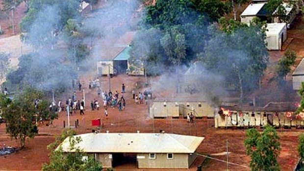 Bad memories of isolation and uncertainty  ...  detainees gather after a building at Curtin is set alight in March 2001.