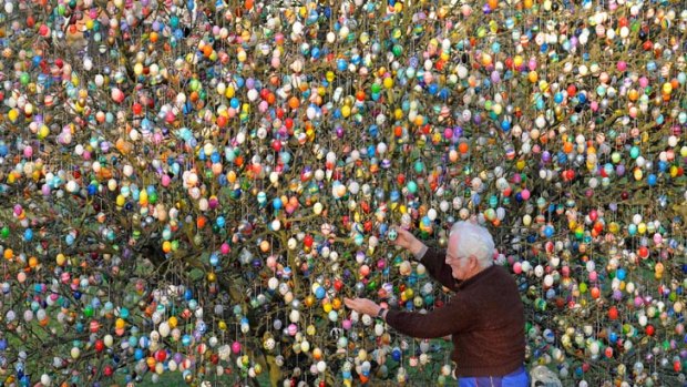 Volker Kraft decorates a tree with 10,000 Easter eggs in the garden of the retired couple Christa and Volker Kraft in Saalfeld, Germany.