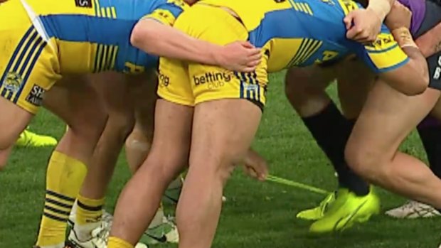 Cheeky: Eels hooker Cameron King unties Slade Griffin's bootlace during a scrum.