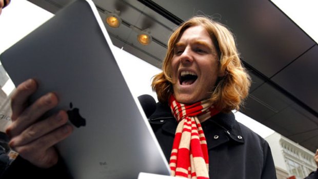 Andreas Schobel reacts after being among the first to purchase an Apple iPad.
