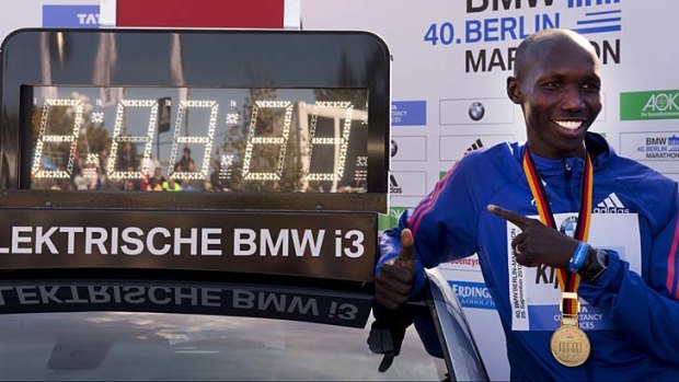 Kenya's Wilson Kipsang poses with his new world record time after winning the 40th edition of the Berlin Marathon.