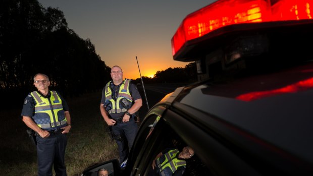 Always there: Senior Sergeant Ralph Willingham and Leading Senior Constable Terry Smith, with Leading Senior Constable Larry Piscioneri in the rear-view mirror. 