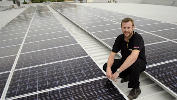 Queens SUPA IGA manager Stuart Bain shows off the store's new solar panels.