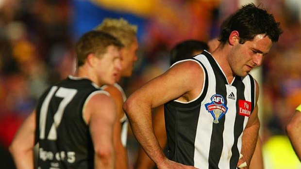 A stark reflection: Collingwood's Alan Didak, far left, in 2003 after the Magpies' grand final loss to the Lions.