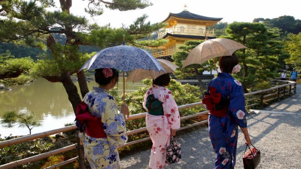 Kimono-clad women at the Kinkakuji Temple in Kyoto, Japan.
