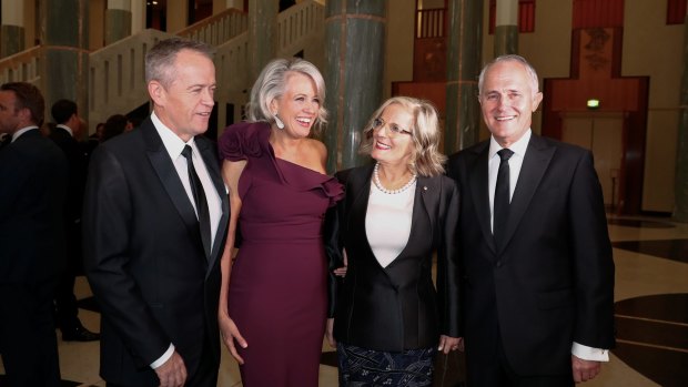 Opposition Leader Bill Shorten, Chloe Shorten, Lucy Turnbull and Prime Minister Malcolm Turnbull arrive for the Midwinter Ball at Parliament House in Canberra on Wednesday.