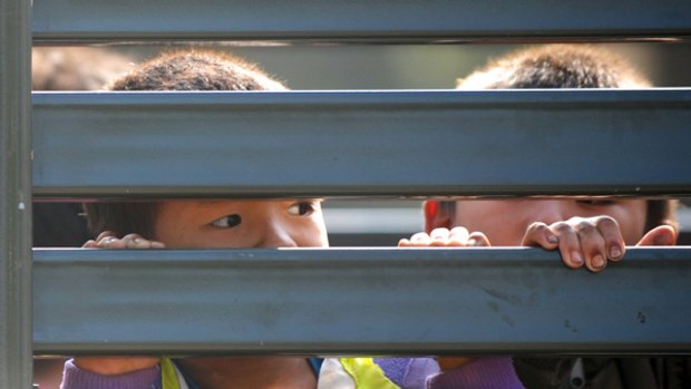 Denied refuge … a Thai military truck holds Hmong children near a camp at Huay Nam Khao during a mass deportation on December 28.