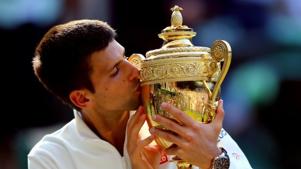 Defending champion: Novak Djokovic celebrates last year's Wimbledon triumph.
