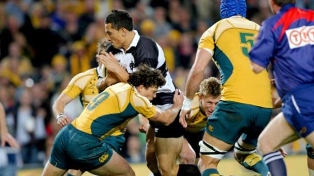 Opening Gambit ... halfback Luke Burgess stops Sonny Bill Williams in his tracks during a Wallabies-Barbarians match at the SFS last year.