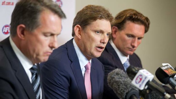 Eye of the storm ... Essendon CEO Ian Robson, president David Evans and coach James Hird faced the media on Monday over the club's alleged use of illegal supplements last season.