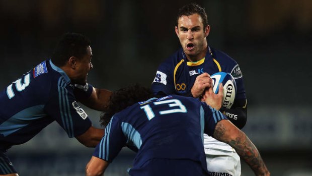 Brumbies scrumhalf Nic White gets tackled against the Auckland Blues on Saturday.