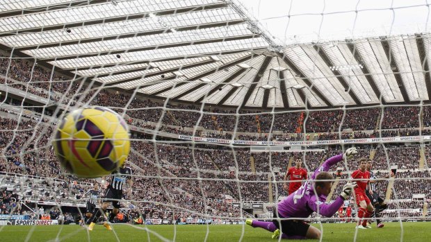Newcastle's Ayoze Perez scores against Liverpool at St James' Park on Saturday. 
