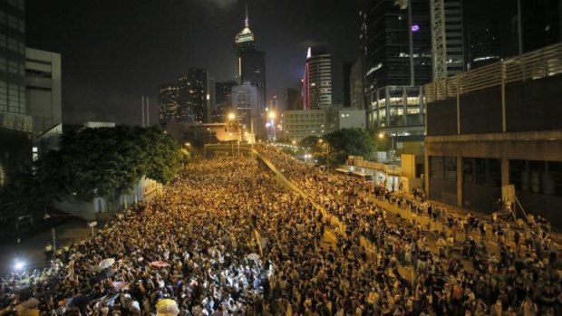 Protesters gather at a main road at the financial central district after riot police use tear gas against them after thousands of people blocked the road in Hong Kong.